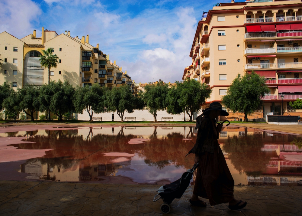 Woman walks home after the rain